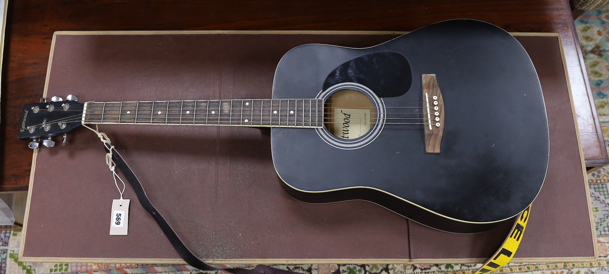 An Eastwoods acoustic guitar, 105cms high